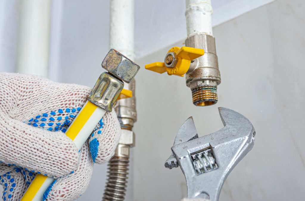 A technician is replacing or connecting a gas pipe